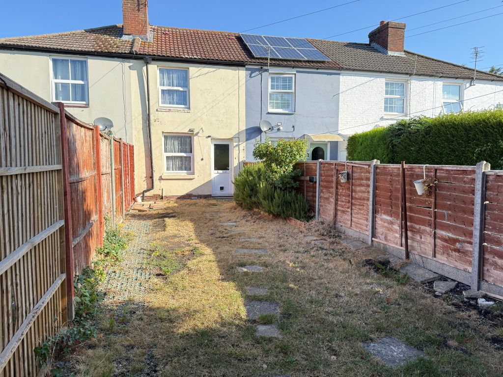 Lot: 136 - TWO-BEDROOM MID-TERRACE HOUSE FOR IMPROVEMENT - View of garden with house in background